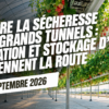 Rampes de goutte-à-goutte alimentant des plants de fraises sur substrat sous un grand tunnel